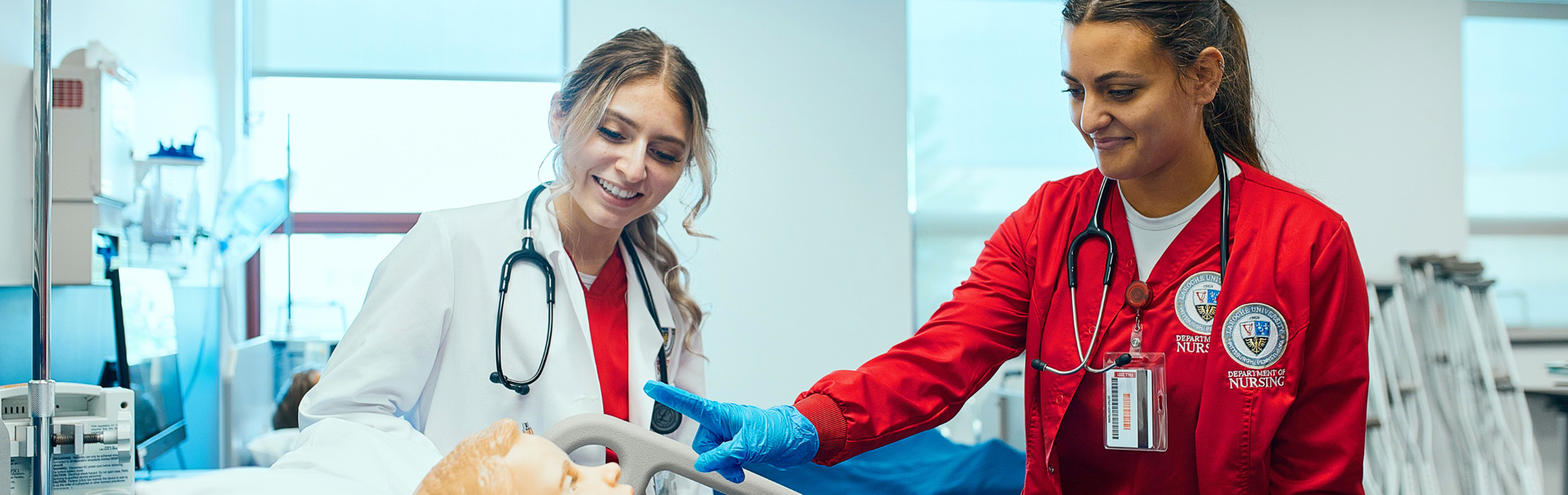 Two female La Roche students in the SIM lab.