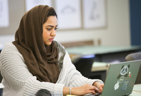 A student works at her computer in the interior design studio at La Roche University. 