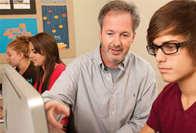 La Roche faculty with student at computer