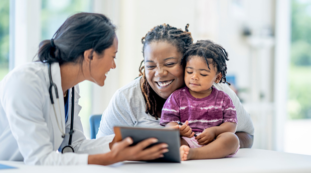 Medical personel interacting with a mother and daughter