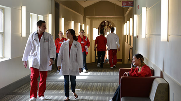 Nursing students walking hallway at La Roche University