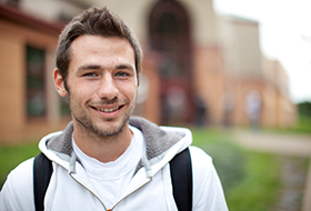 Male La Roche University student outside Campus Center Square