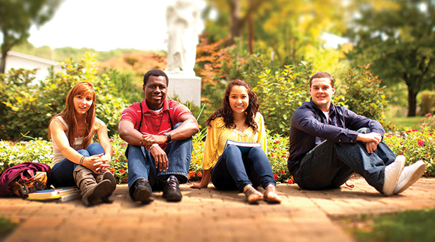 Students sitting on sidewalk outside chapel