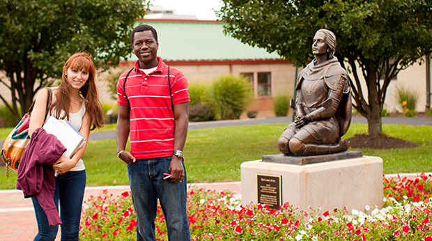 Students by Joan of Arc statue