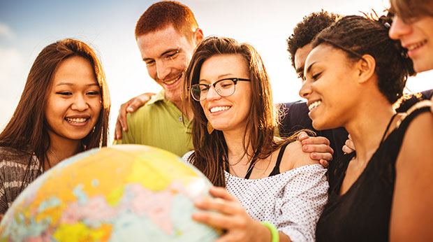  College student smiling with globe