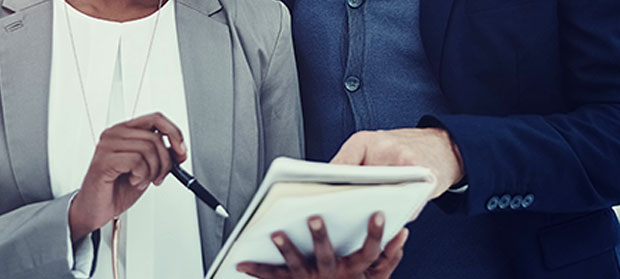 Two individuals looking at their schedule