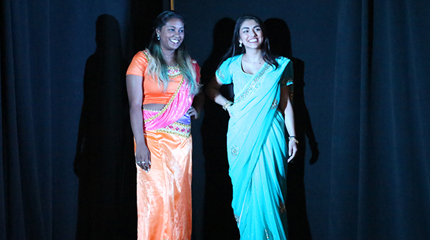 Two female students modeling clothing at the annual GLOBE Fashion Show in the Kerr Fitness & Sports Center
