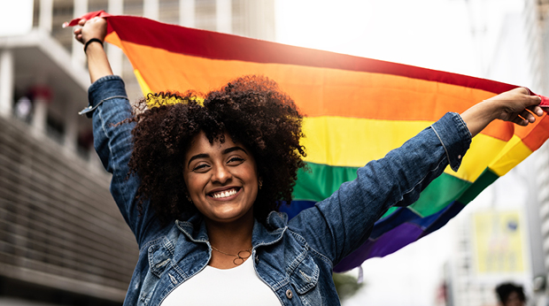 Person holding a rainbow flag