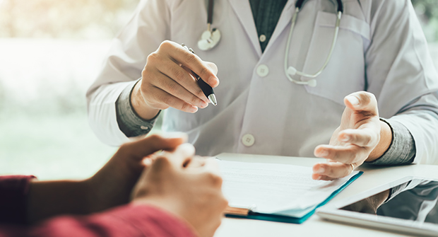 Doctor consulting with patient at desk