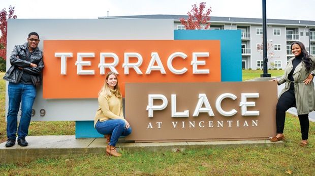 LRC students around the sign outside to Terrance Place